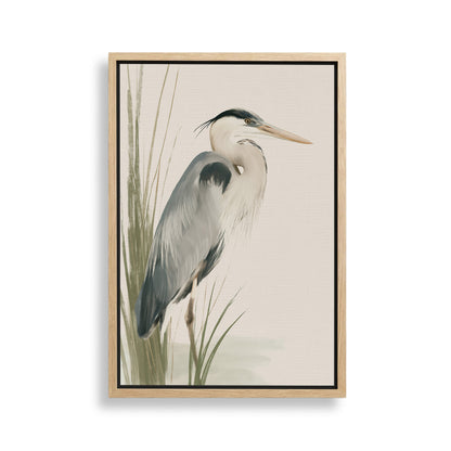 A framed painting depicting a heron standing in tall grass.