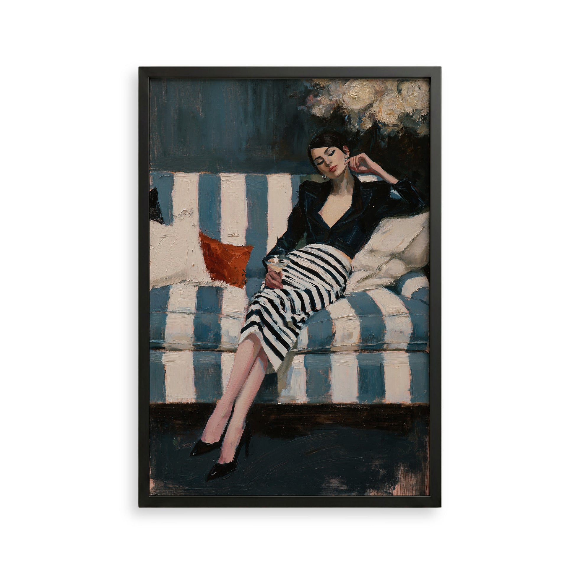A woman in a black and white striped dress is sitting on a blue and white striped couch, holding a drink in her hand.