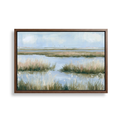 The image is a framed painting depicting a serene landscape with a body of water surrounded by tall grasses and a cloudy sky.