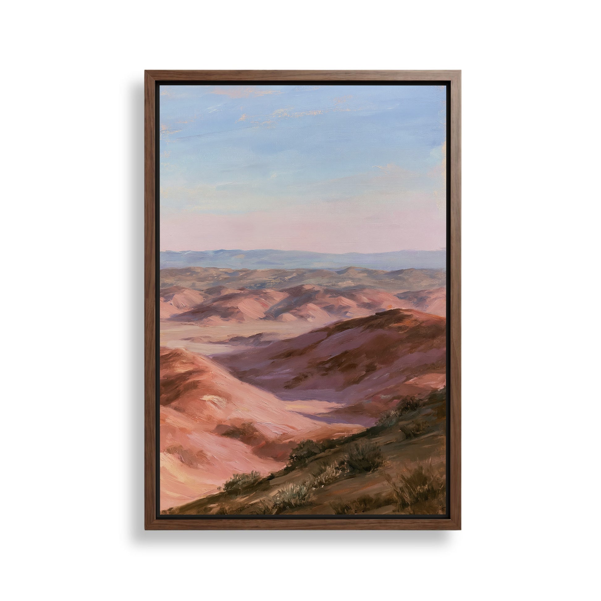 The image is a framed painting depicting a scenic landscape with rolling hills and mountains under a clear blue sky.