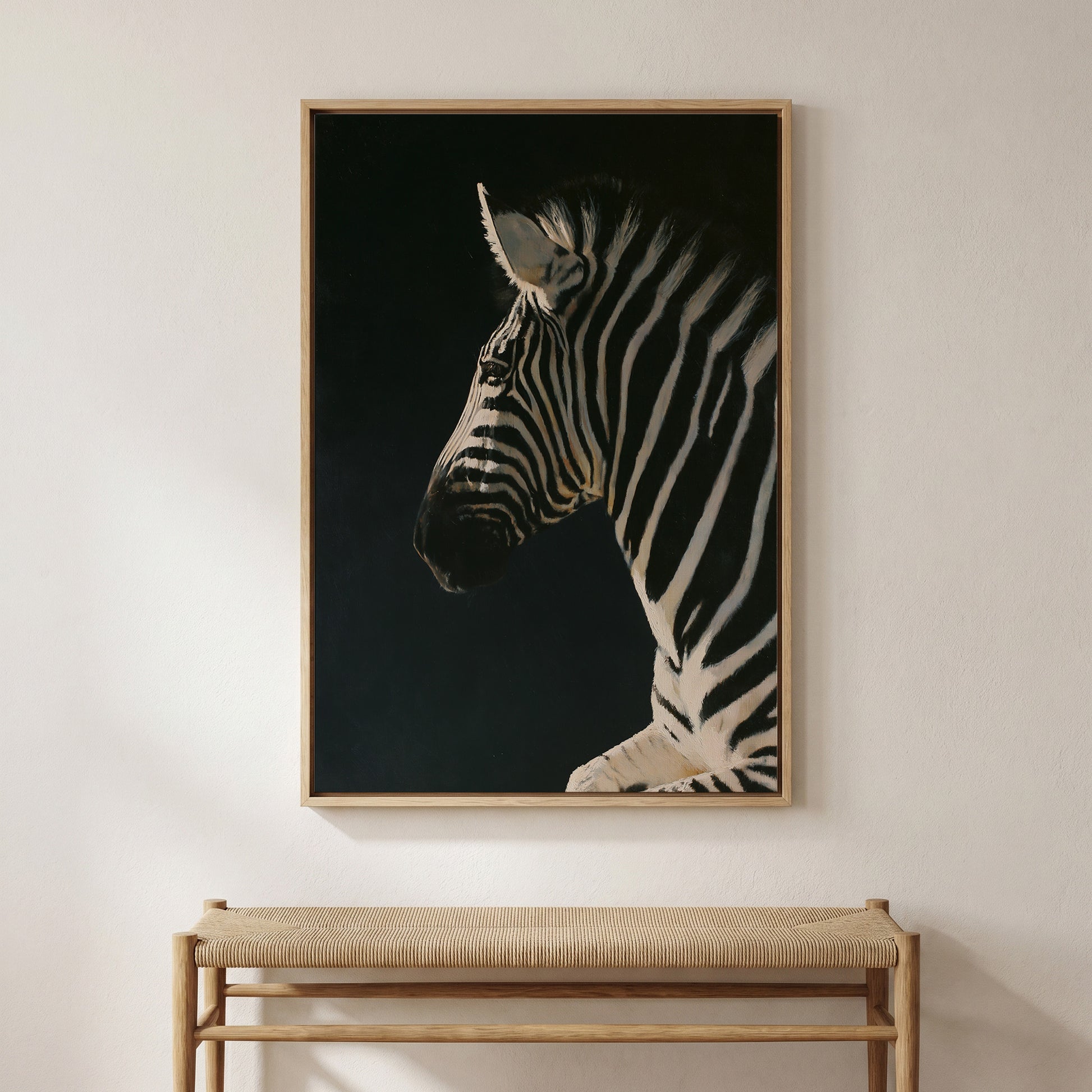 a large, framed painting of a zebra's profile, hanging on a wall above a wooden bench.