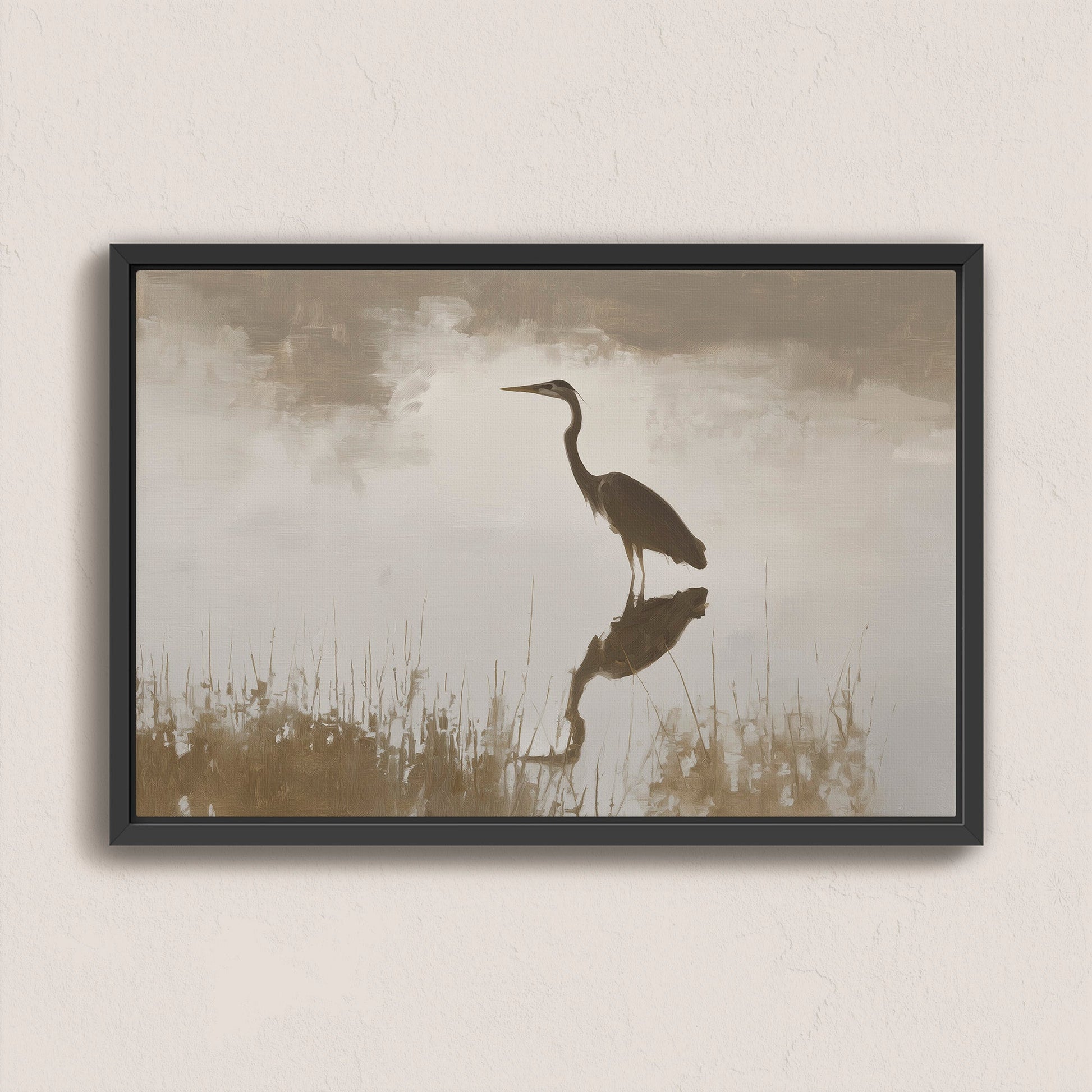 Wade canvas print featuring a heron standing in serene water with muted earth tones and soft light in a black frame