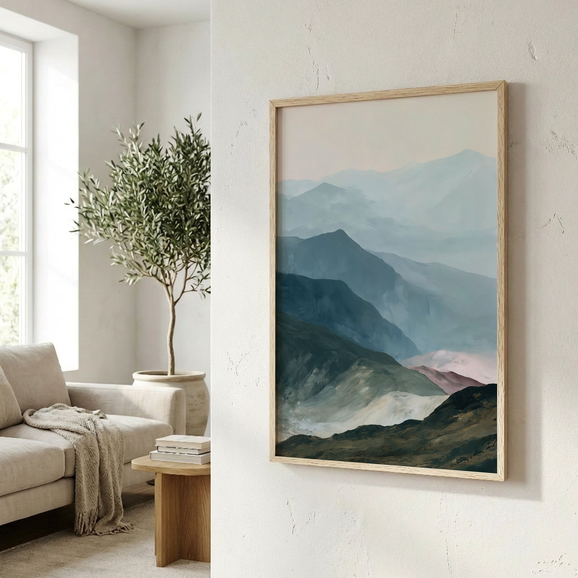 a framed painting of a mountain landscape hanging on a wall, with a cozy living room scene visible in the background.