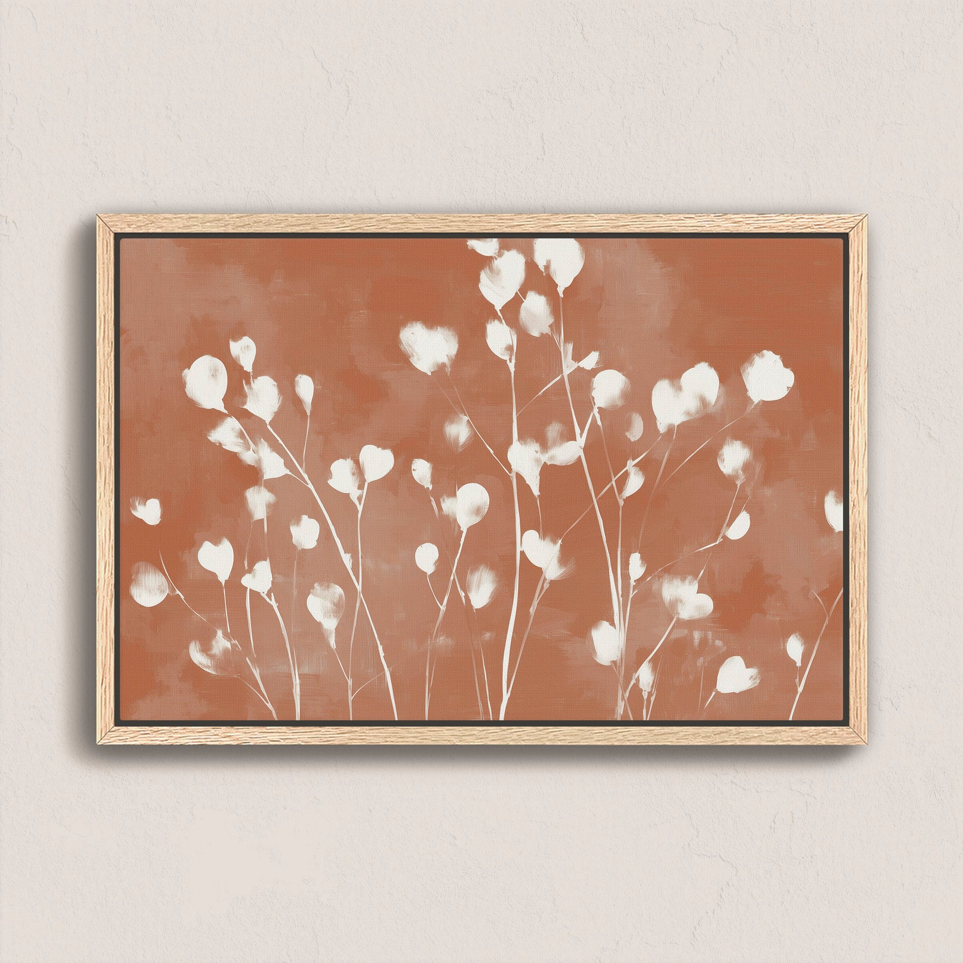 Ember canvas print with white floral petals on terracotta background in natural wood frame