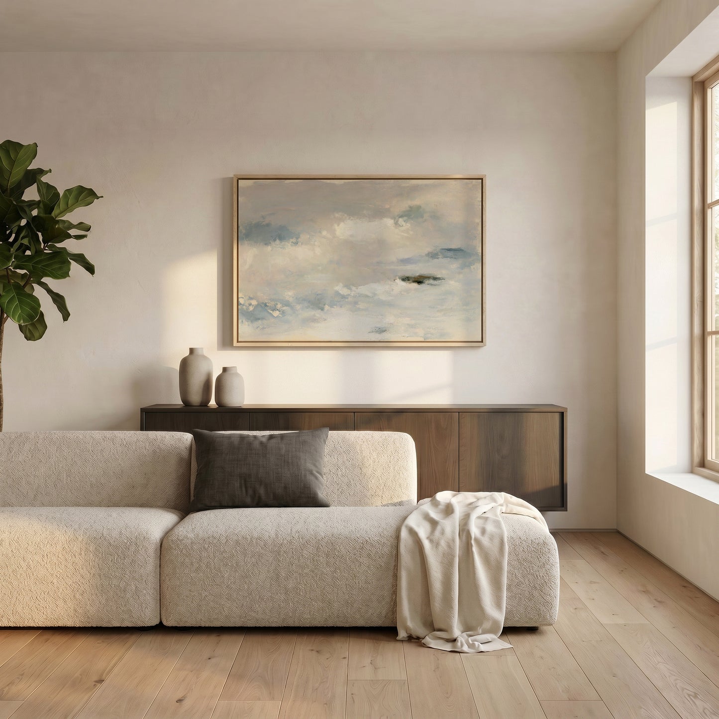 a modern living room with a large window, a white sofa, a wooden cabinet, and a framed painting of a cloudy sky on the wall.