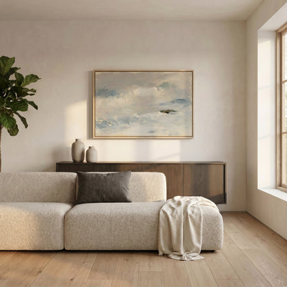 a modern living room with a large window, a white sofa, a wooden cabinet, and a framed painting of a cloudy sky on the wall.