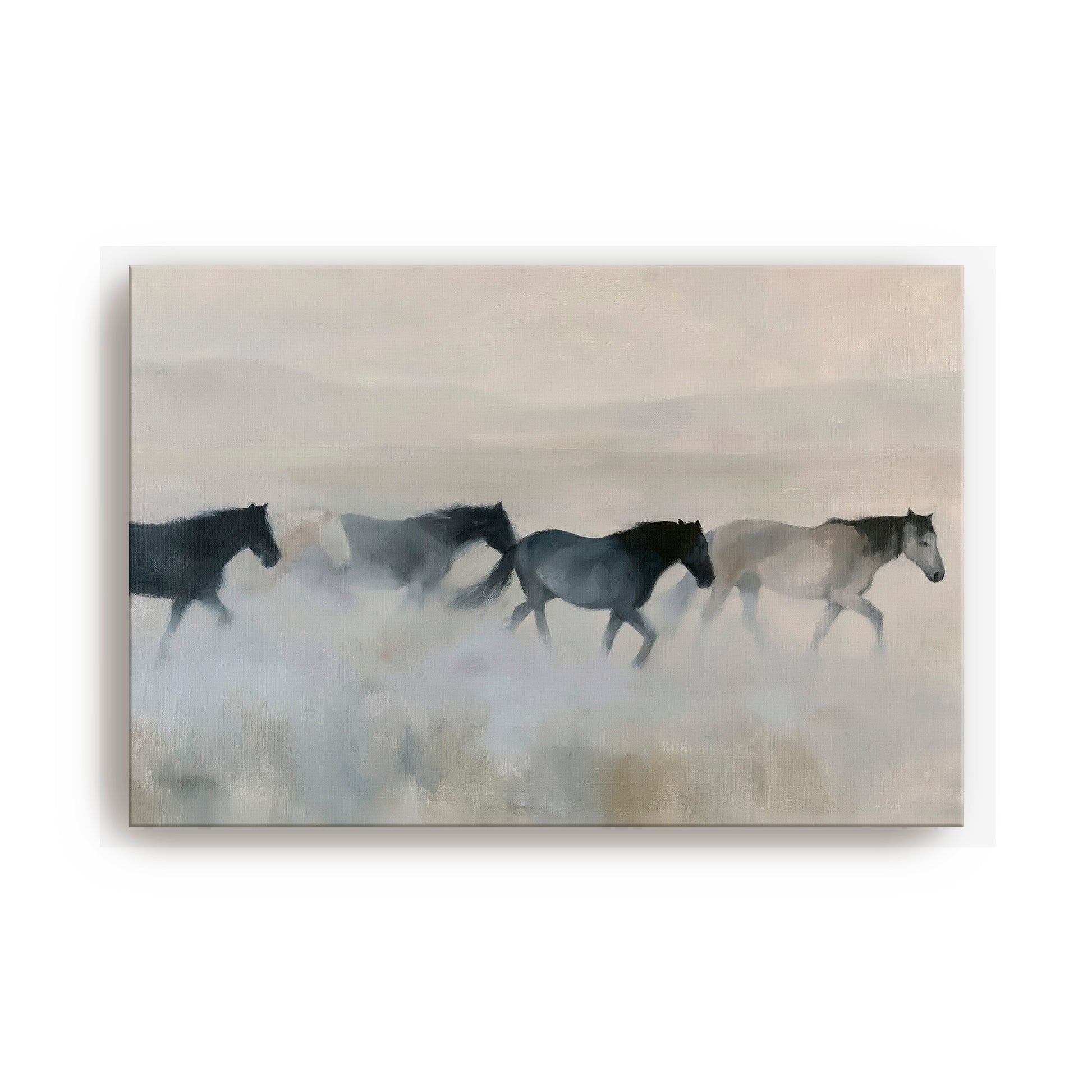 A group of horses running across a field, with a hazy, misty background.