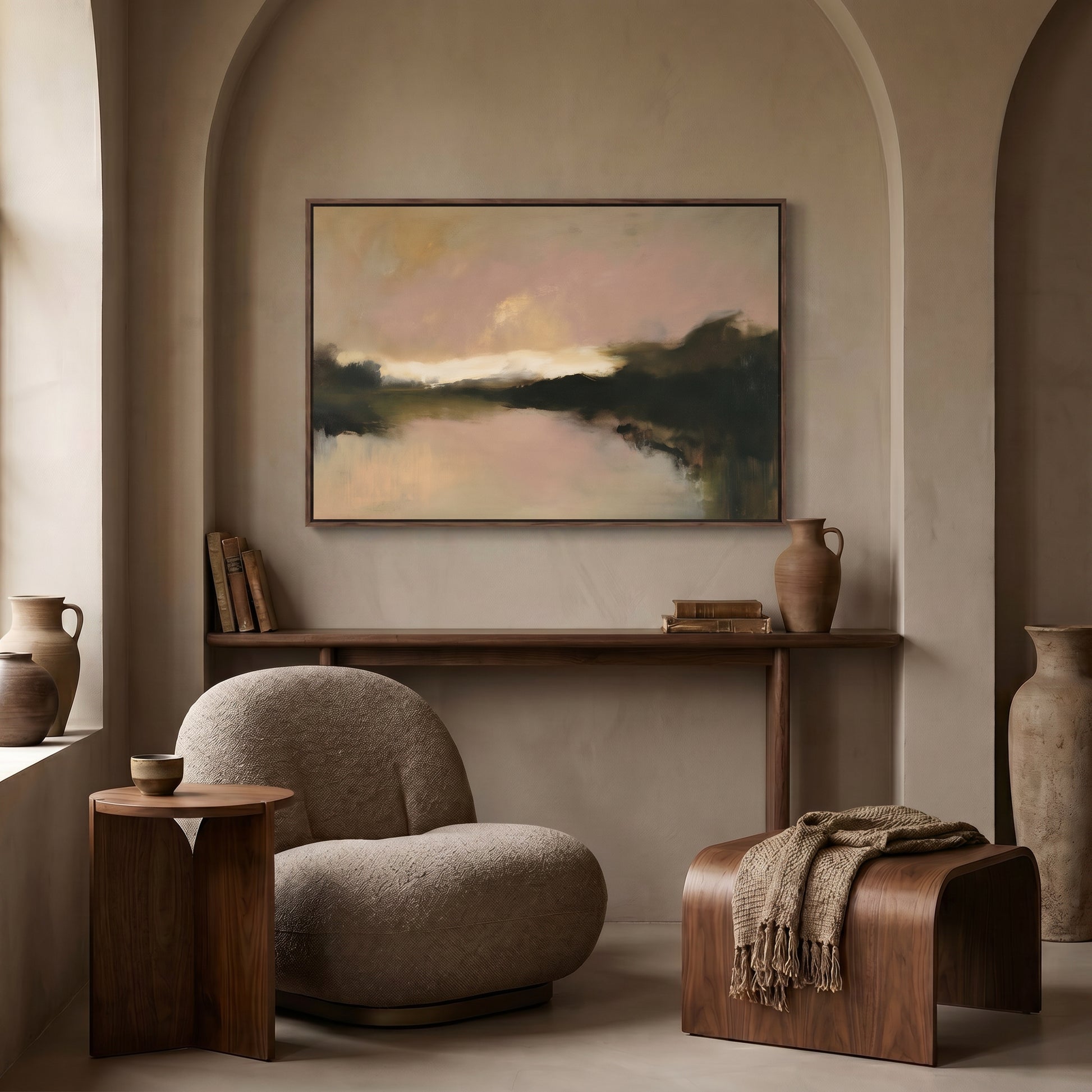 a cozy living room with a large abstract painting hanging on the wall above a wooden console table. The console table has a vase, a book, and a bowl on it. There is a comfortable armchair and a wooden ottoman in the room, creating a warm and inviting atmosphere.