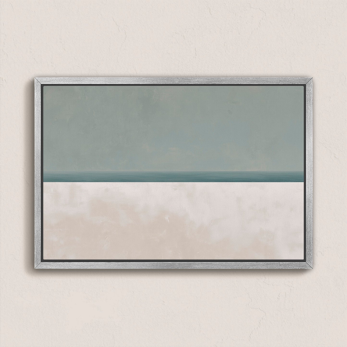 Minimalist Azure canvas print depicting sea and sky in muted sage and sand hues, framed in silver wood.