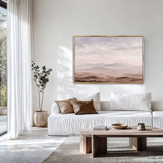 a serene living room with a large window, a white sofa, a wooden coffee table, and a framed landscape painting hanging on the wall.