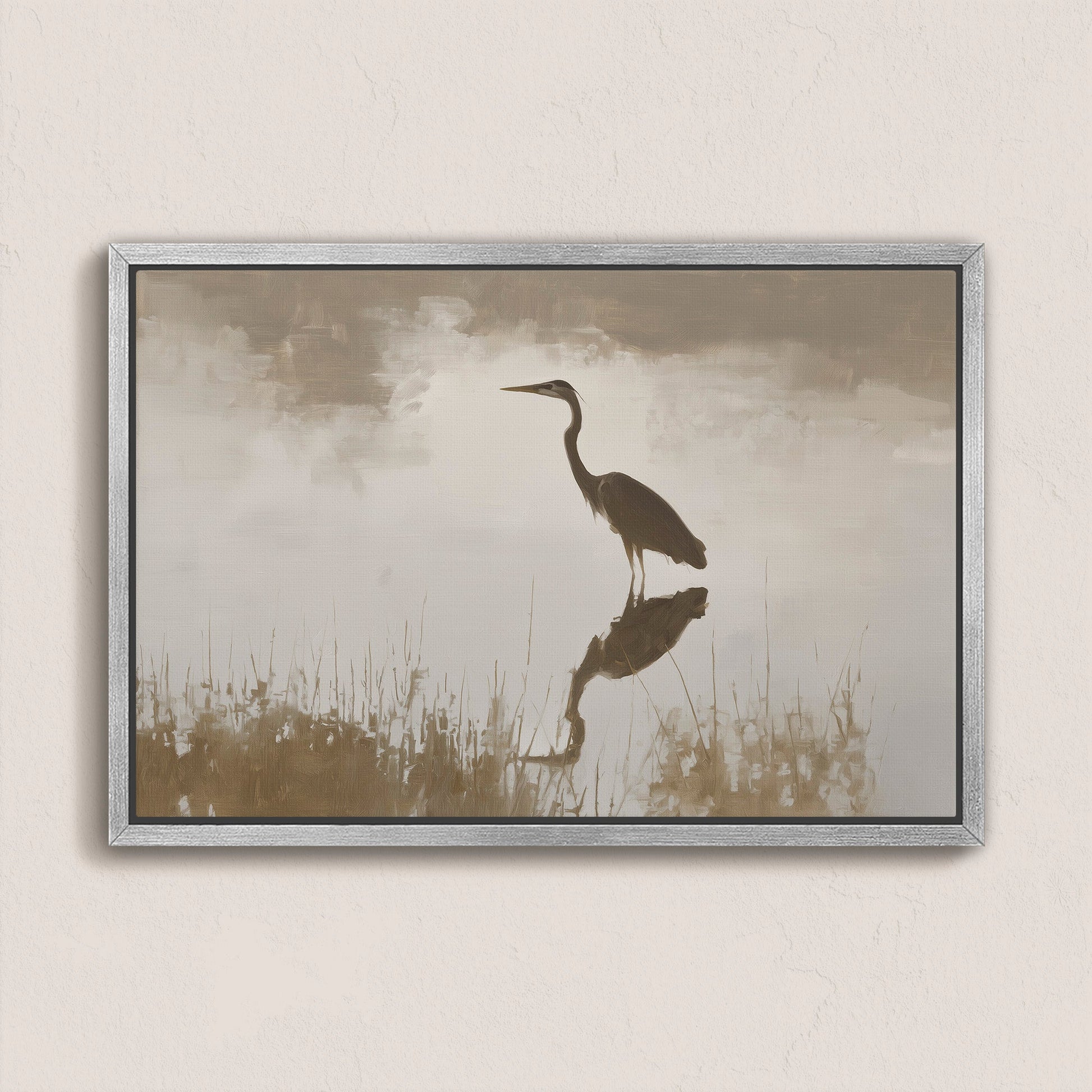 Wade canvas print featuring a heron standing in calm water with soft earth tones and a silver frame