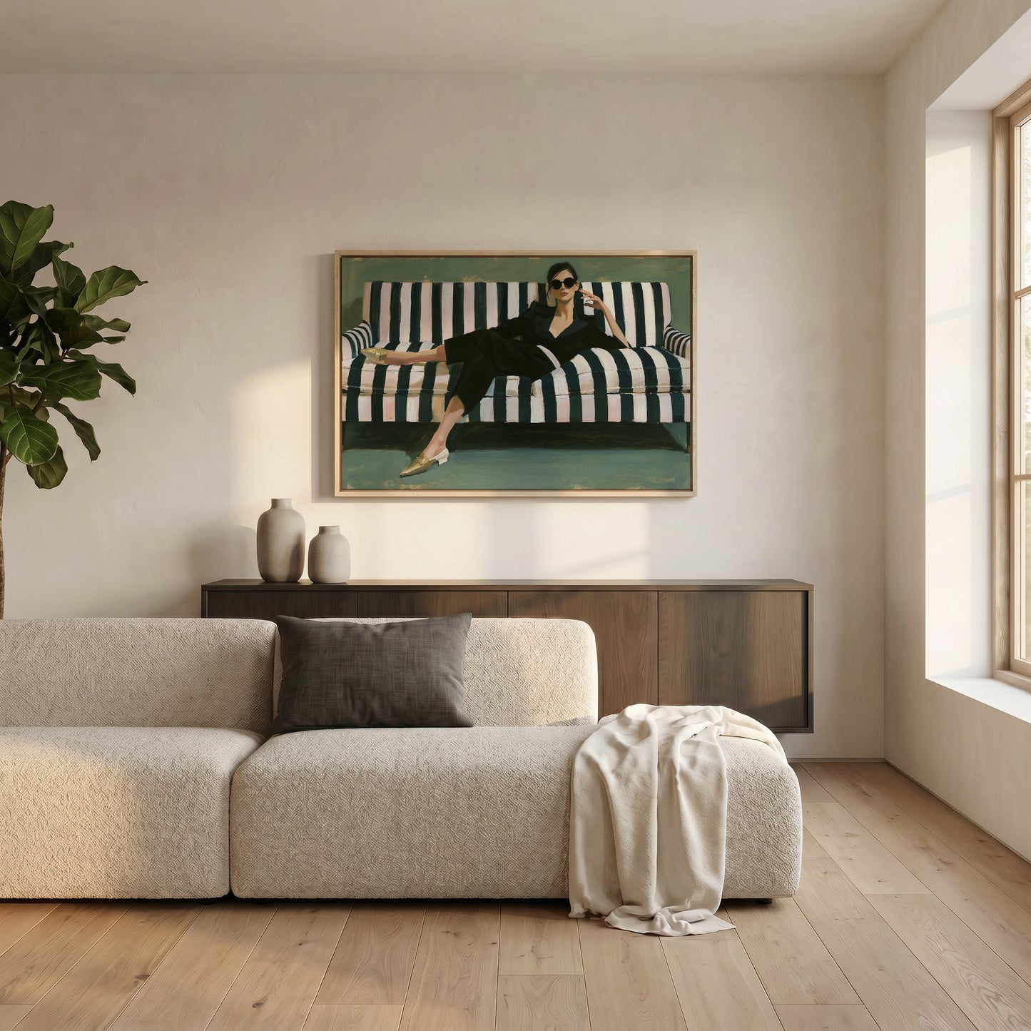 a modern living room with a large window, a white sofa, a wooden cabinet, and a framed painting of a woman in a black dress sitting on a striped couch.