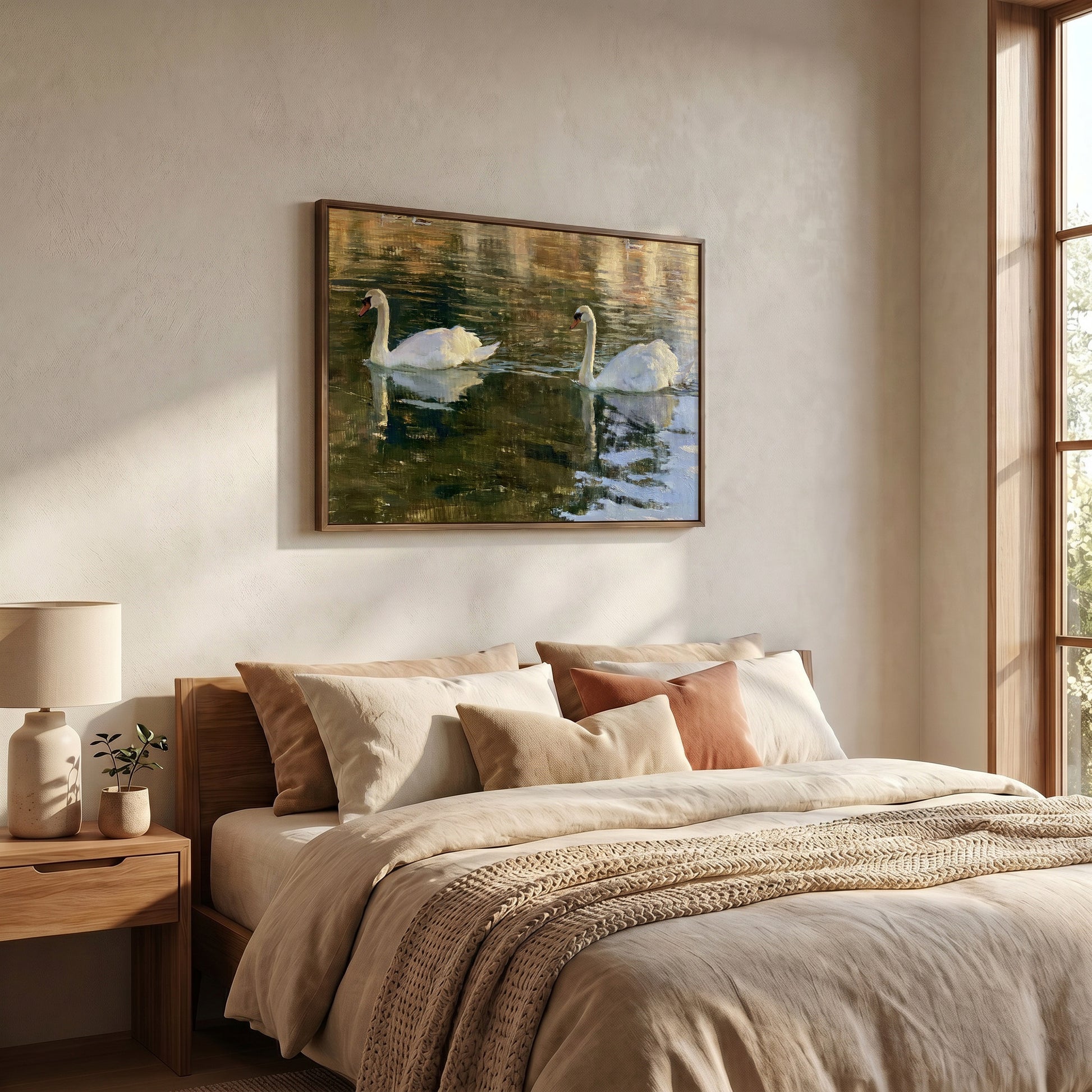a serene bedroom scene with a large bed, a framed painting of two swans on a lake, and a lamp on a side table.