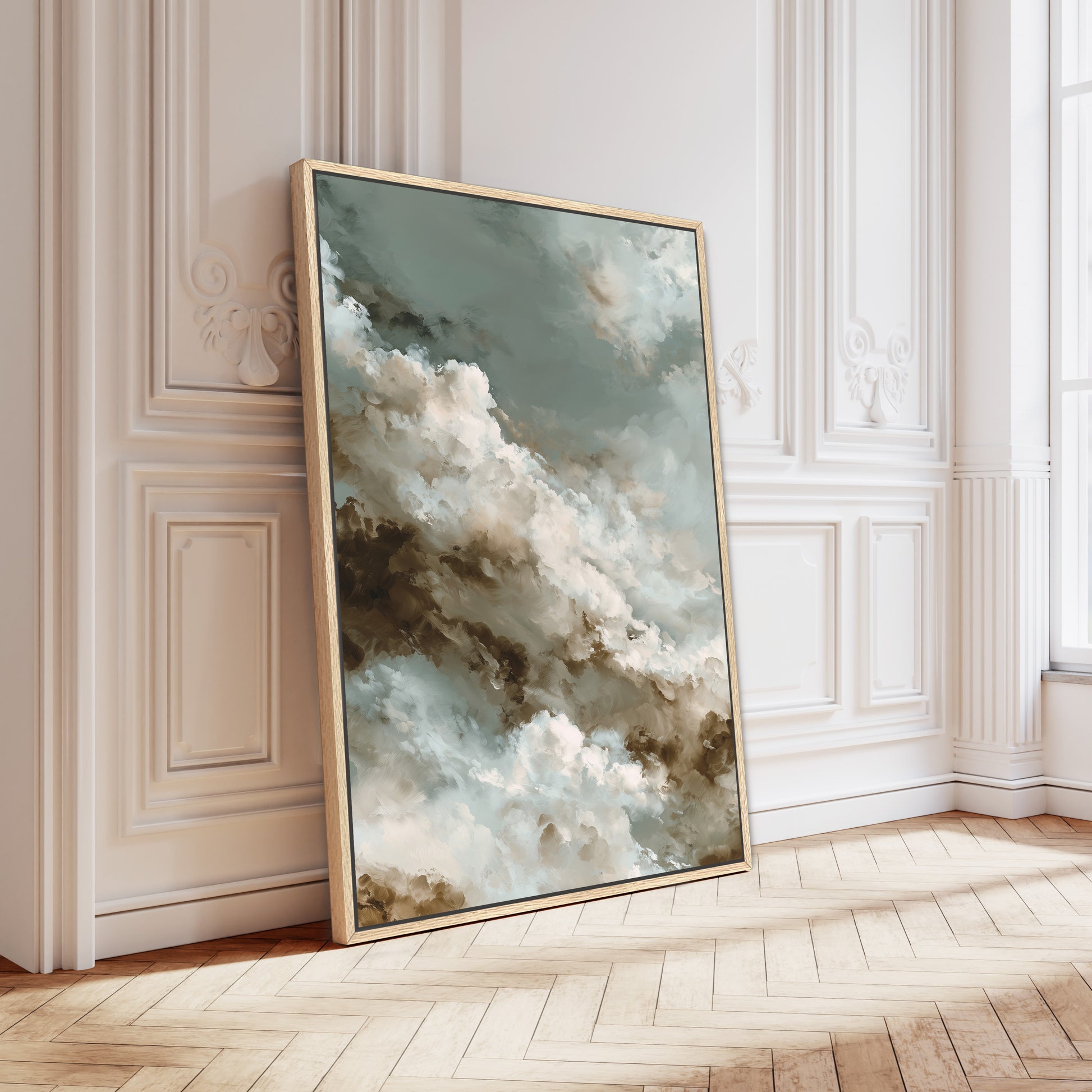 a large, framed painting of a cloudy sky with a mix of blue, white, and brown colors. The painting is leaning against a white wall, and the wooden floor beneath it adds a warm and natural touch to the scene.