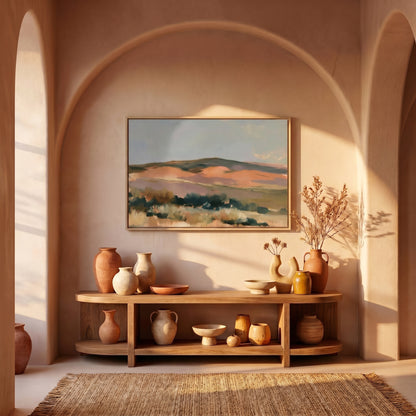 a wooden console table with various vases and bowls displayed on it, set against a wall with a framed landscape painting hanging above.
