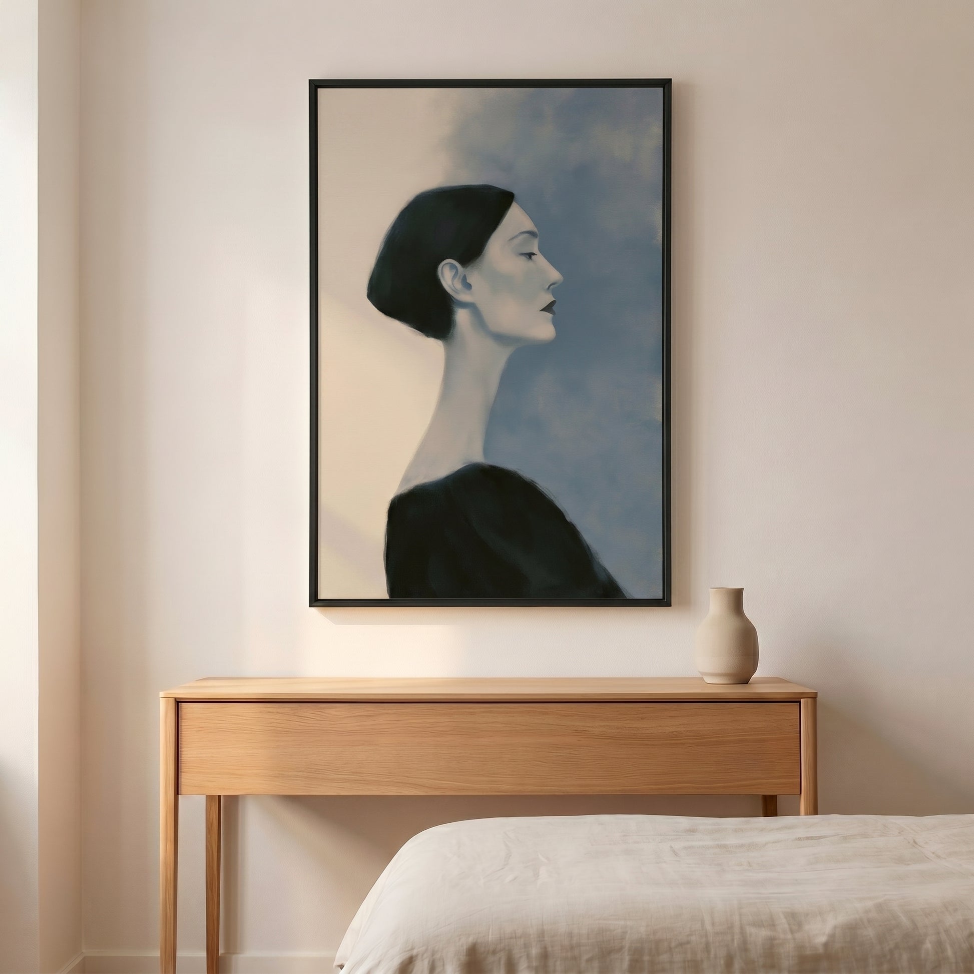 a large black and white portrait of a woman hanging on a wall above a wooden dresser.