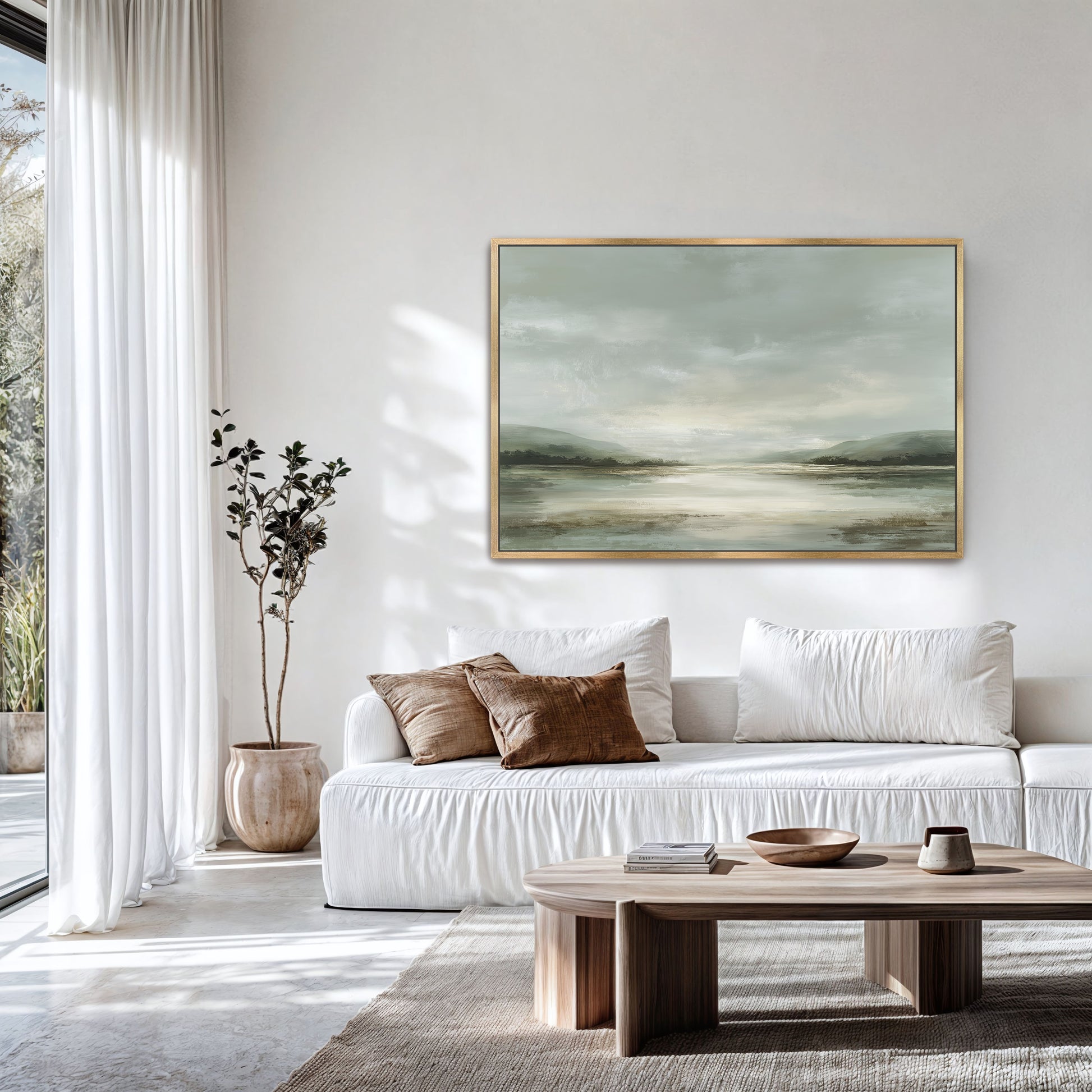 a modern living room with a white sofa, a wooden coffee table, and a large landscape painting hanging on the wall.