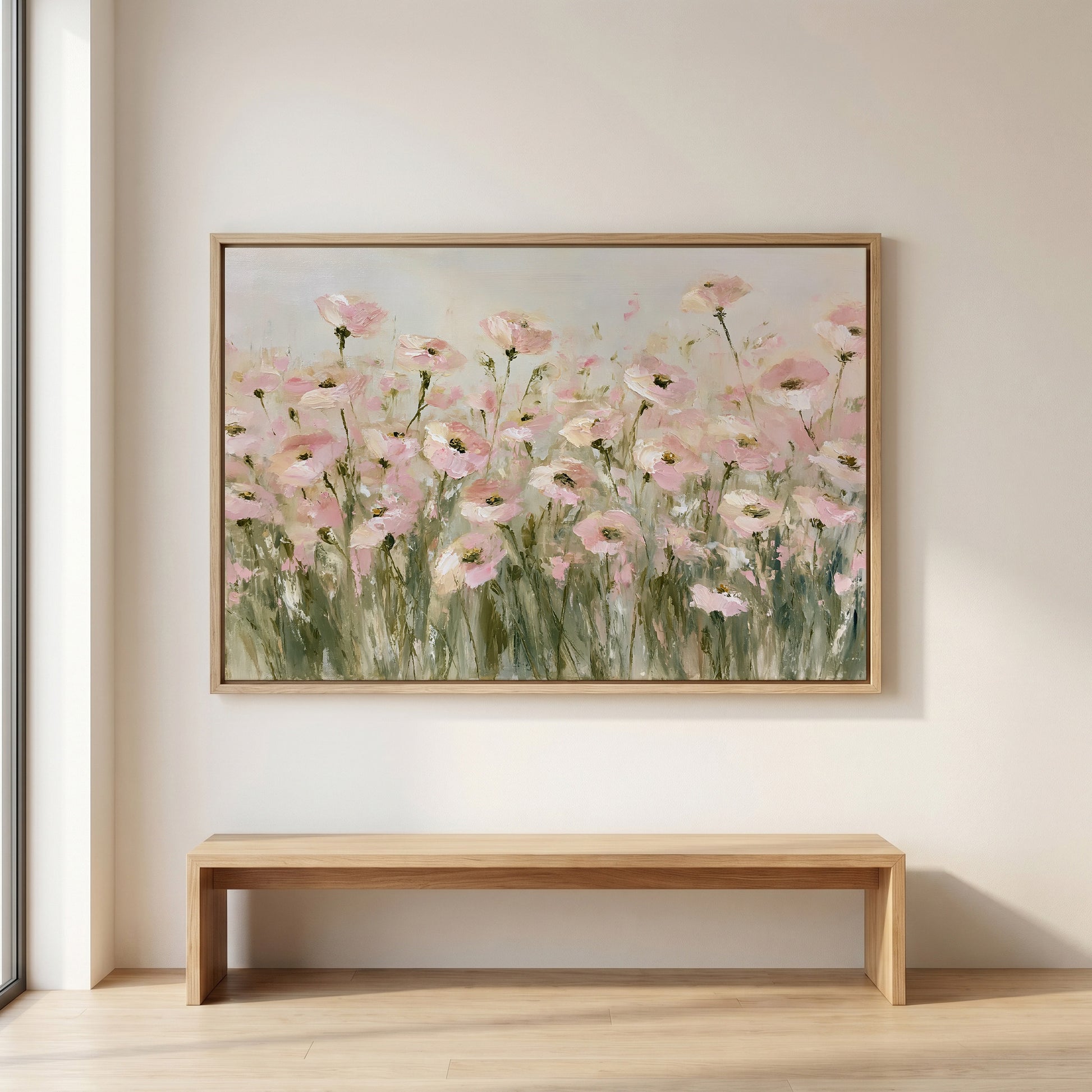 a large painting of pink flowers hanging on a wall above a wooden bench.