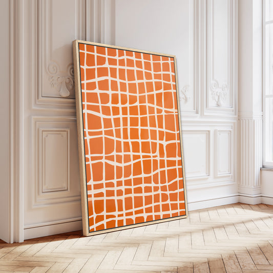a large, vibrant orange and white abstract painting displayed on a white wall in a room with a wooden floor.