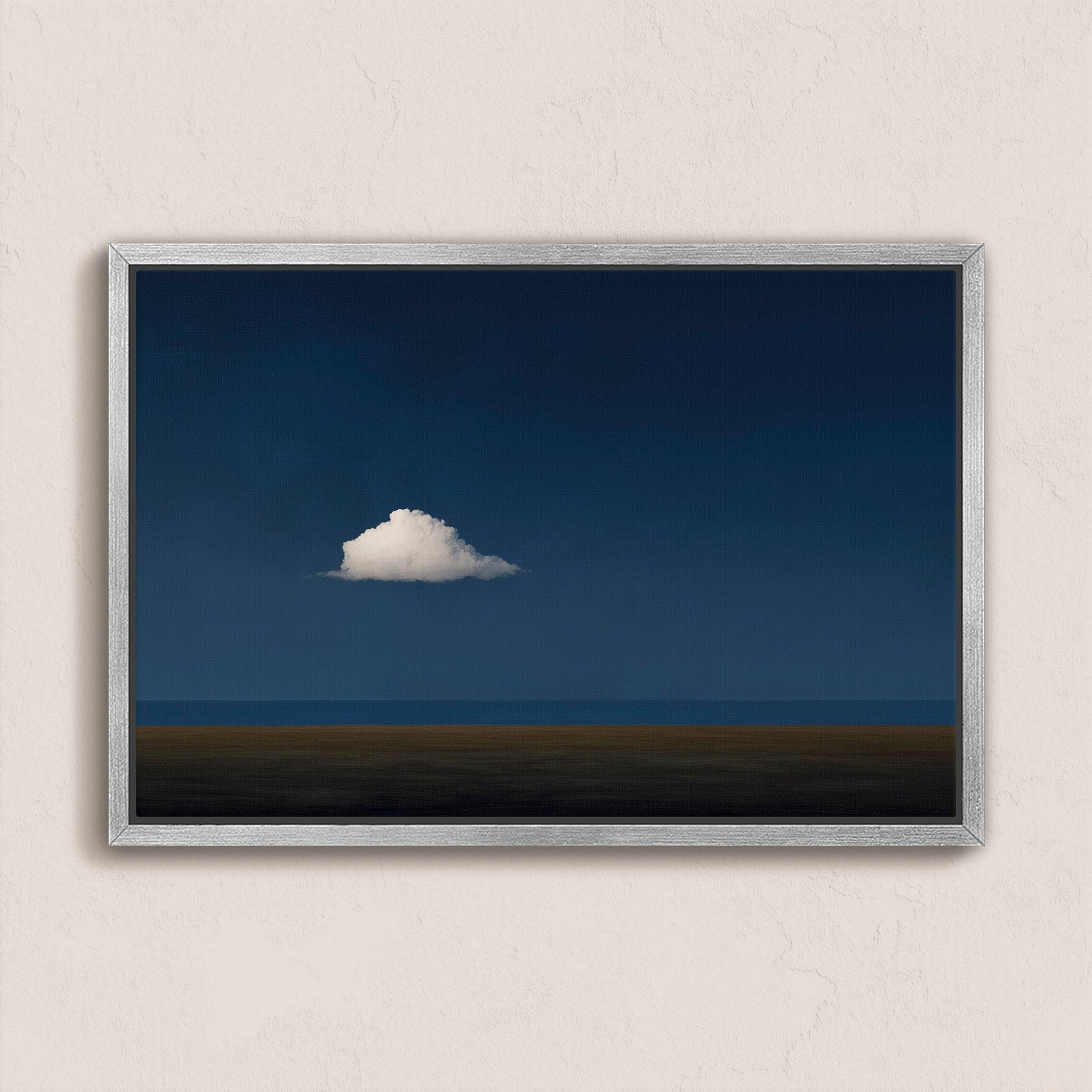 Nimbus Canvas Print featuring a solitary white cloud over a midnight blue horizon in a minimalist framed design