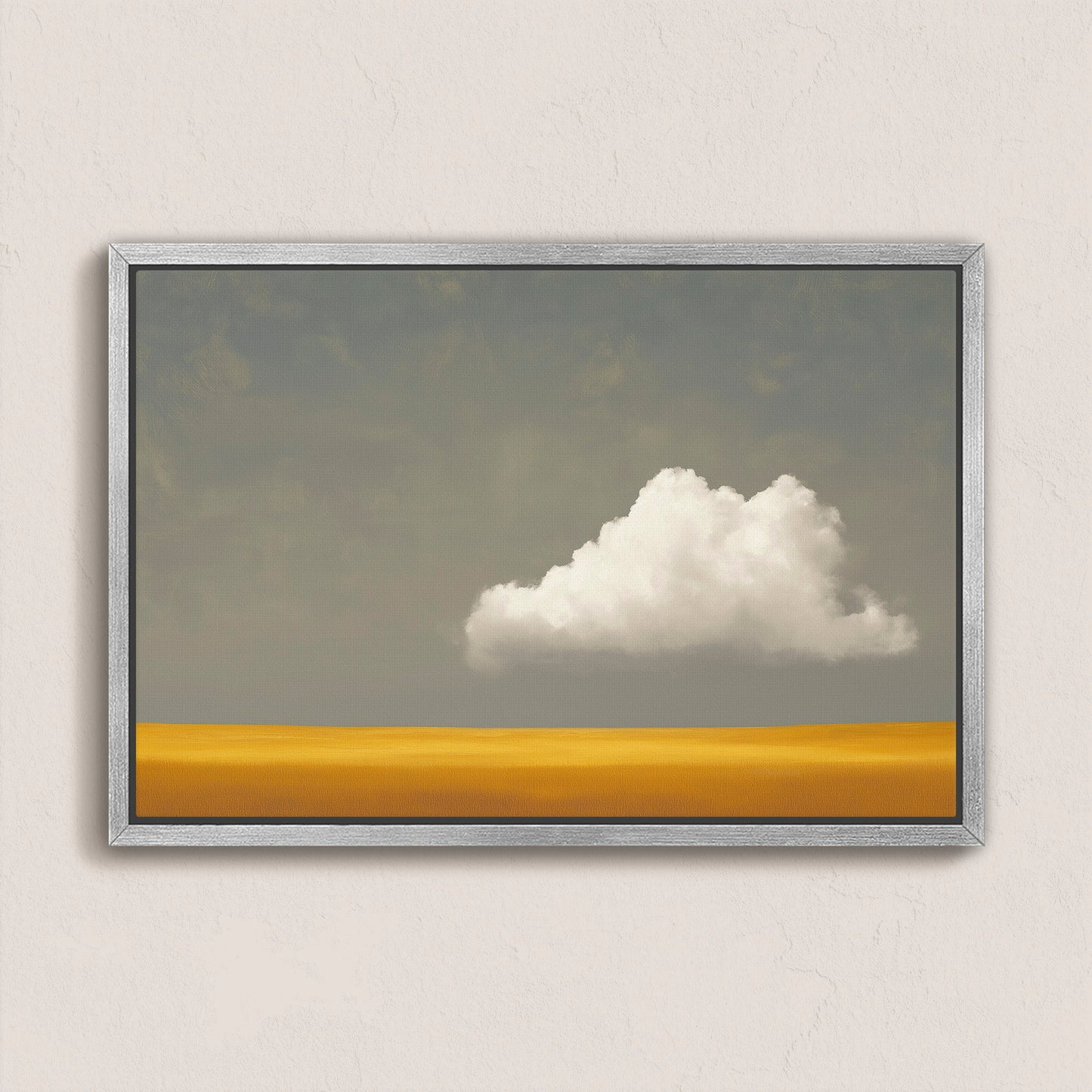 Mellow canvas print featuring a white cloud over a golden plain with a muted gray sky in a silver frame
