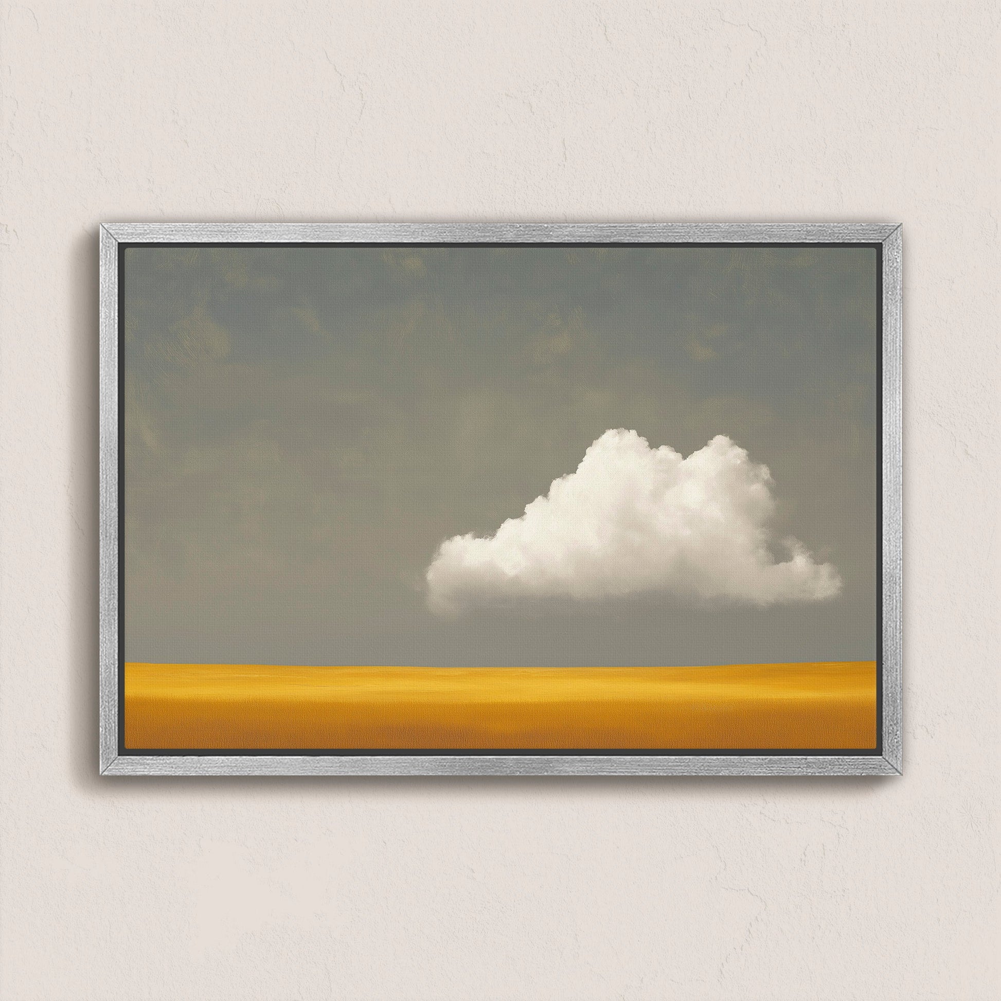 Mellow canvas print featuring a white cloud over a golden plain with a muted gray sky in a silver frame