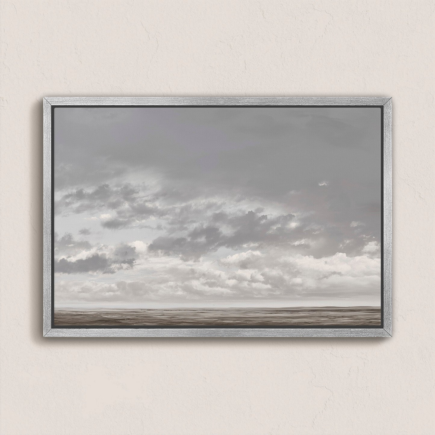 Duskfield canvas print of soft gray clouds over a tranquil plain in muted silvers and taupes, framed in silver-gray wood.