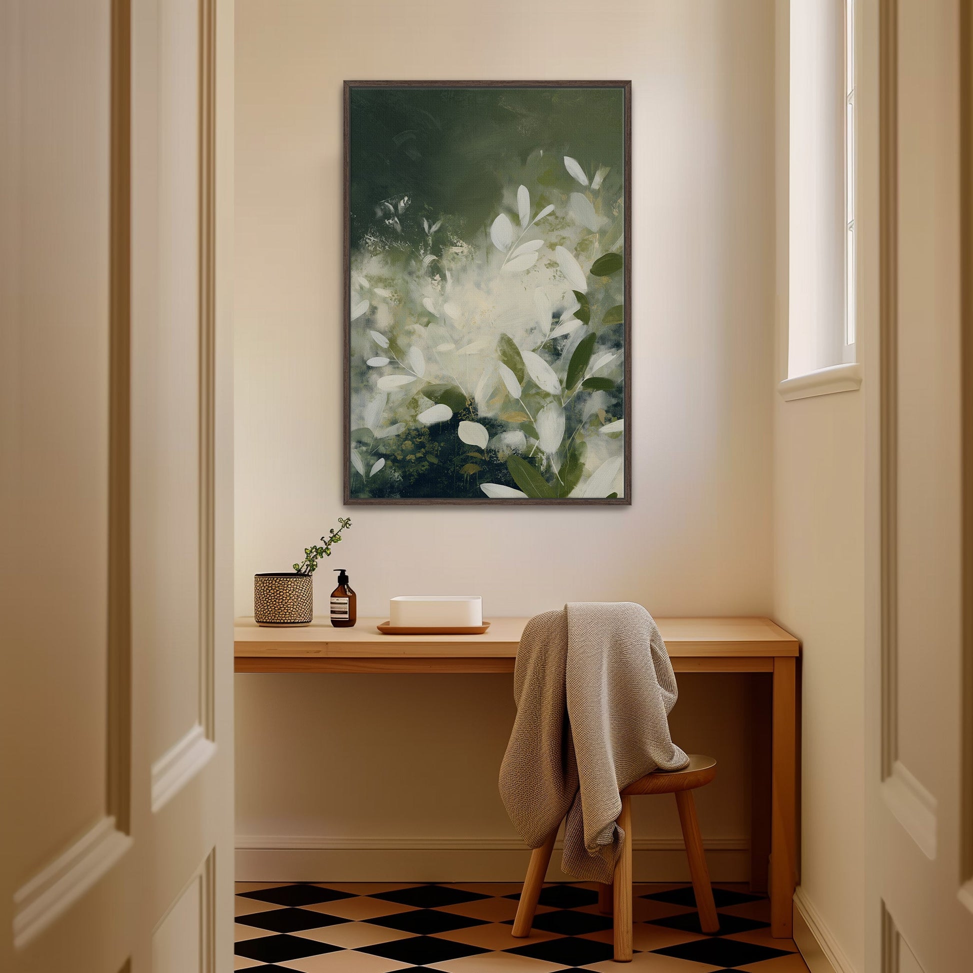 Verdure canvas wall art with soft ivory leaves and deep green tones in a minimalist wooden frame hanging above a desk in a modern room