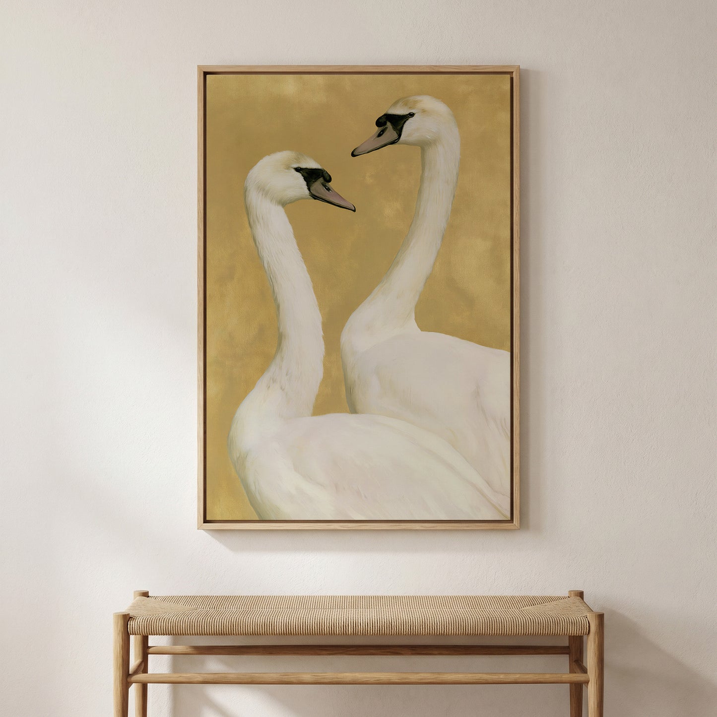 two elegant swans standing close together against a warm yellow background.