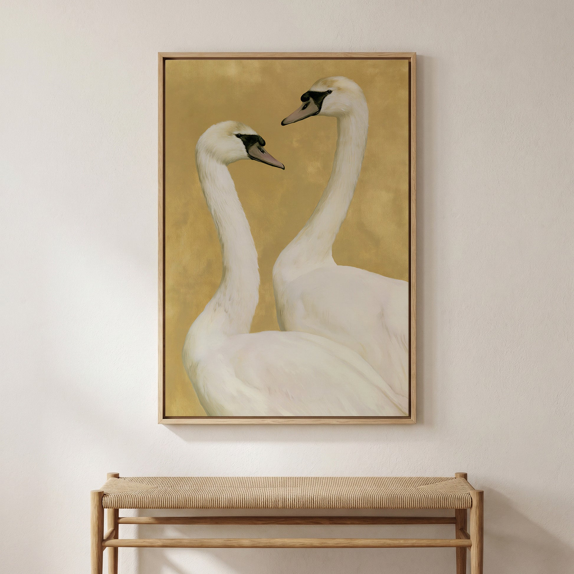 two elegant swans standing close together against a warm yellow background.