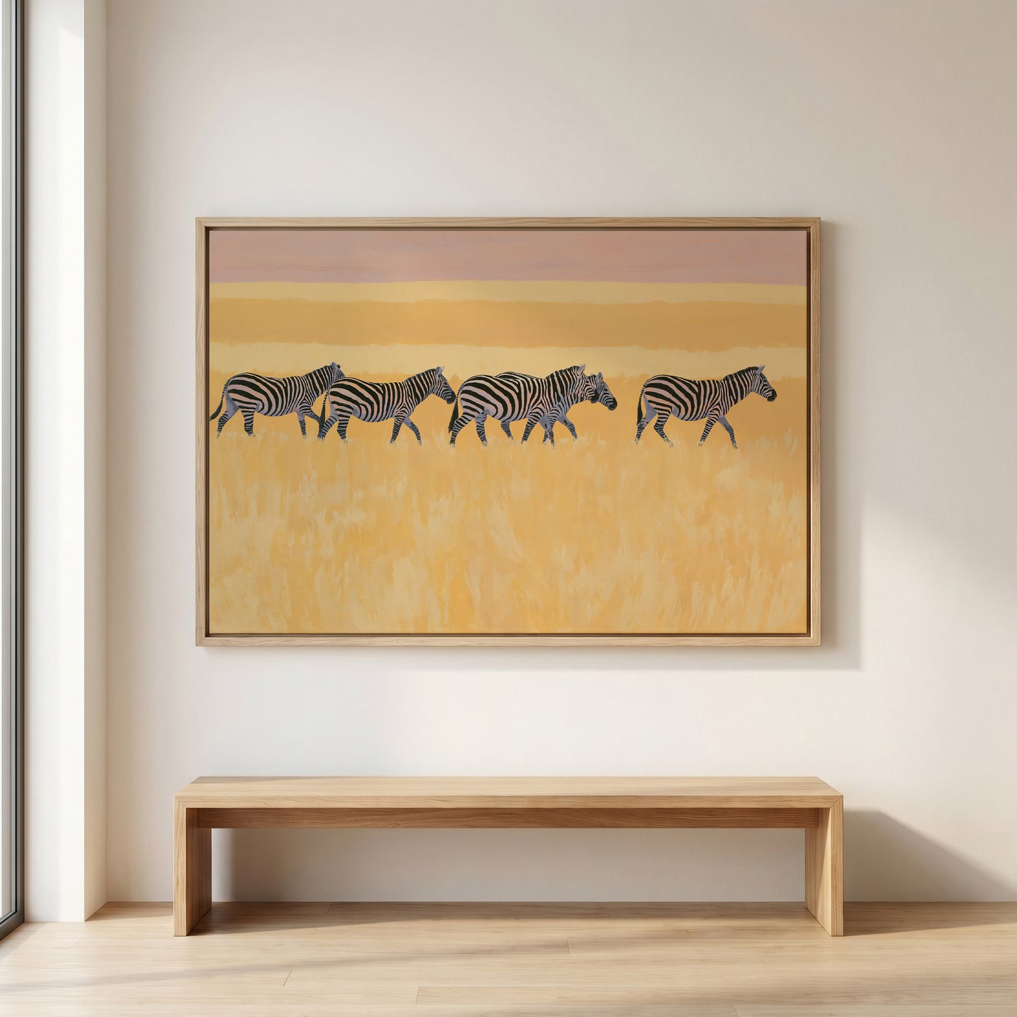 a large painting of zebras in a field, hanging on a wall above a wooden bench.