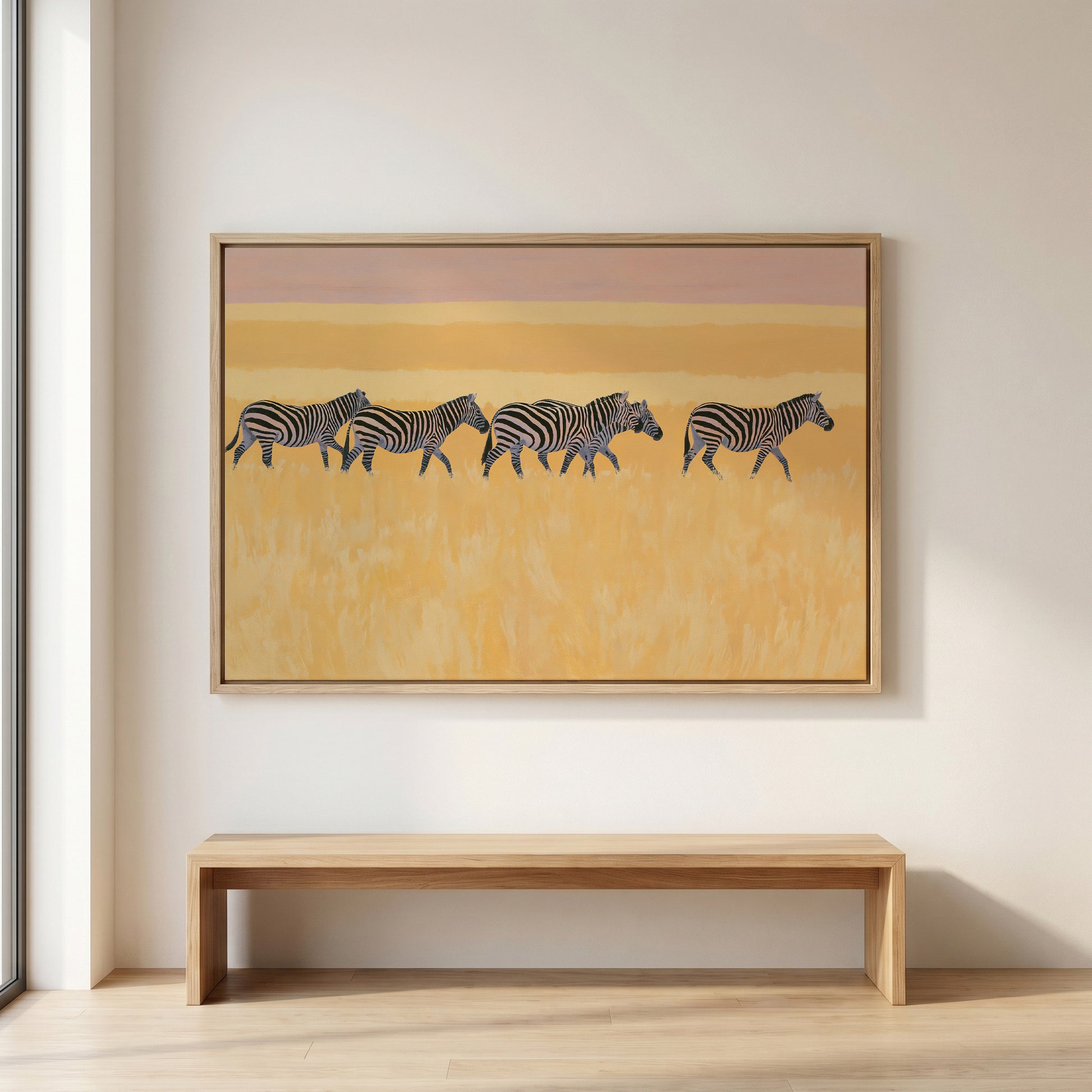 a large painting of zebras in a field, hanging on a wall above a wooden bench.