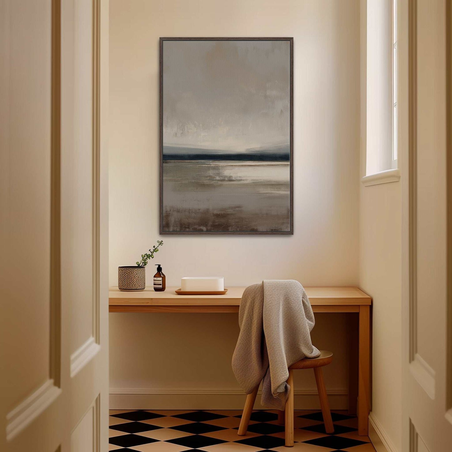 Vast canvas art with taupe, charcoal, and cream gradients in a tranquil landscape, framed and hanging above a wooden desk in a warm modern room
