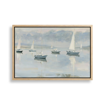 a serene scene of sailboats gently floating on a calm body of water, with a cloudy sky in the background.