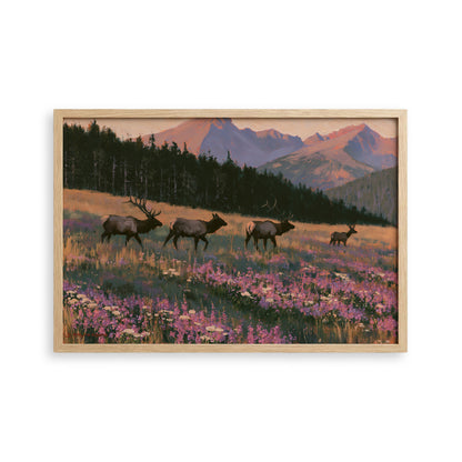 A framed painting depicting a group of elk in a field with mountains in the background.