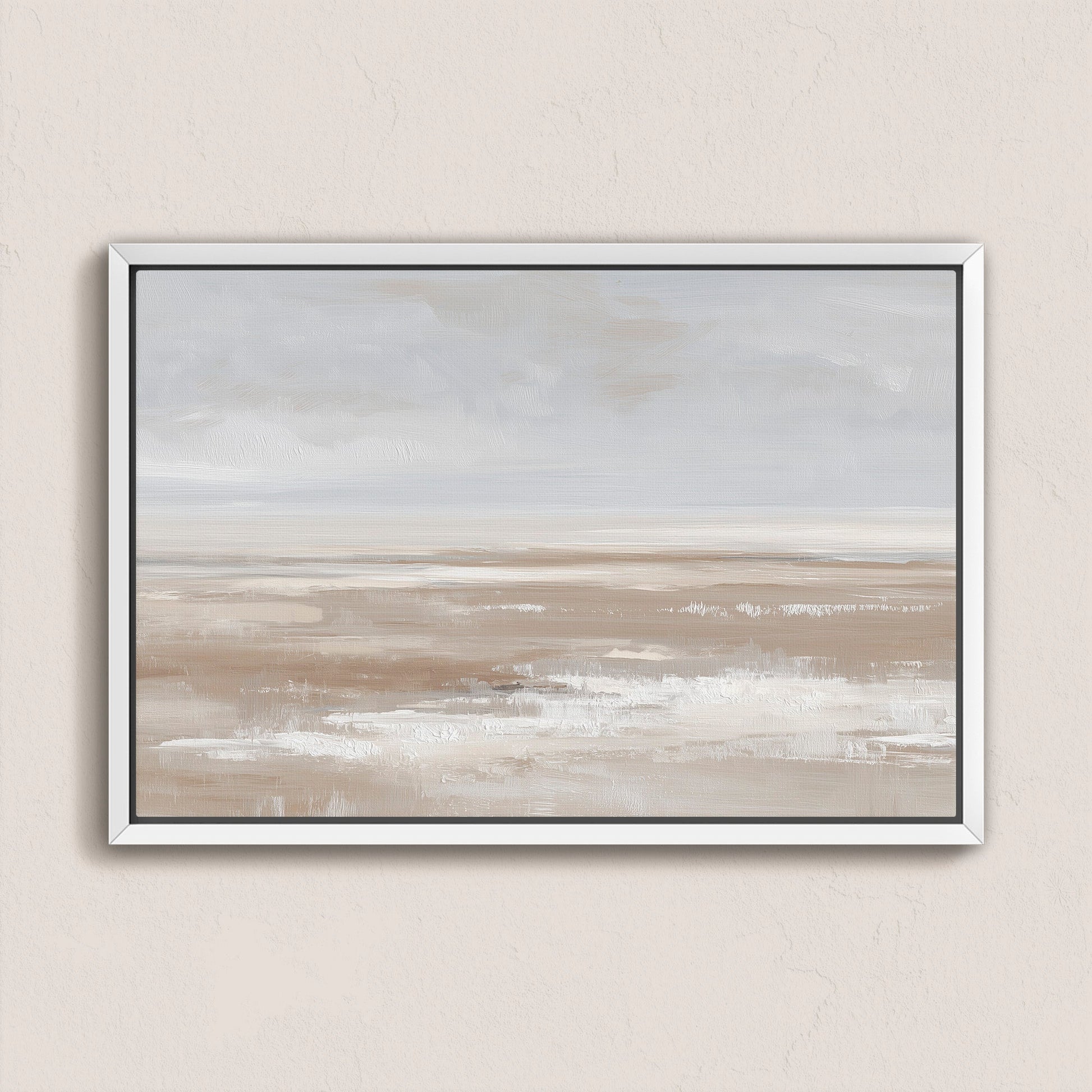 Minimalist barren canvas print with taupe, cream, and sand tones in a white frame hanging on beige wall