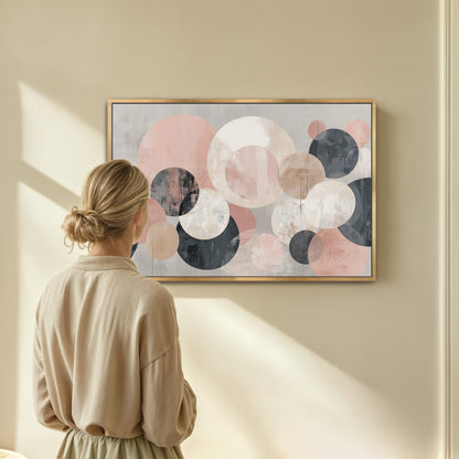 A woman is standing in front of a large abstract painting on a wall, looking at it with interest.