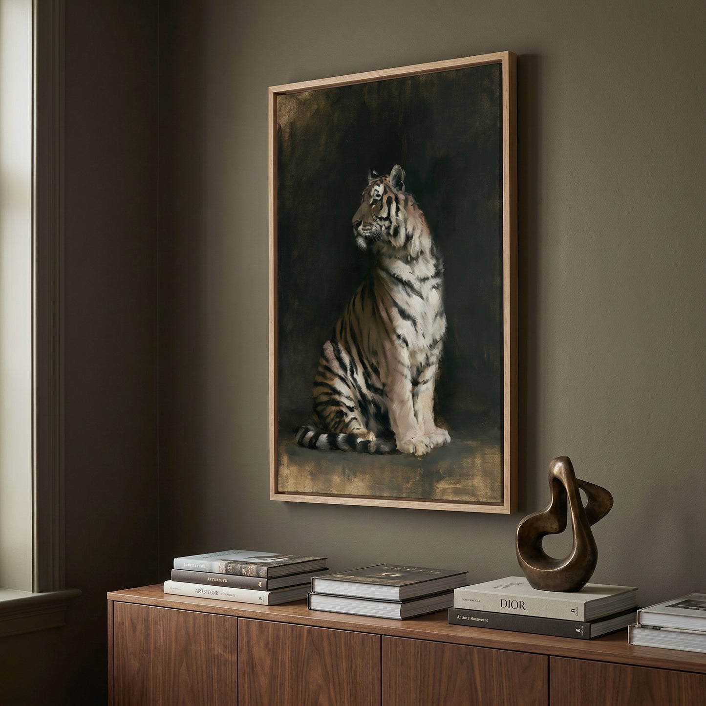 a large framed painting of a tiger sitting on a wooden surface, with a sculpture and a stack of books below it.