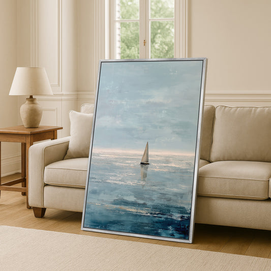 a large painting of a sailboat on the ocean, displayed in a living room setting with a sofa and a lamp.