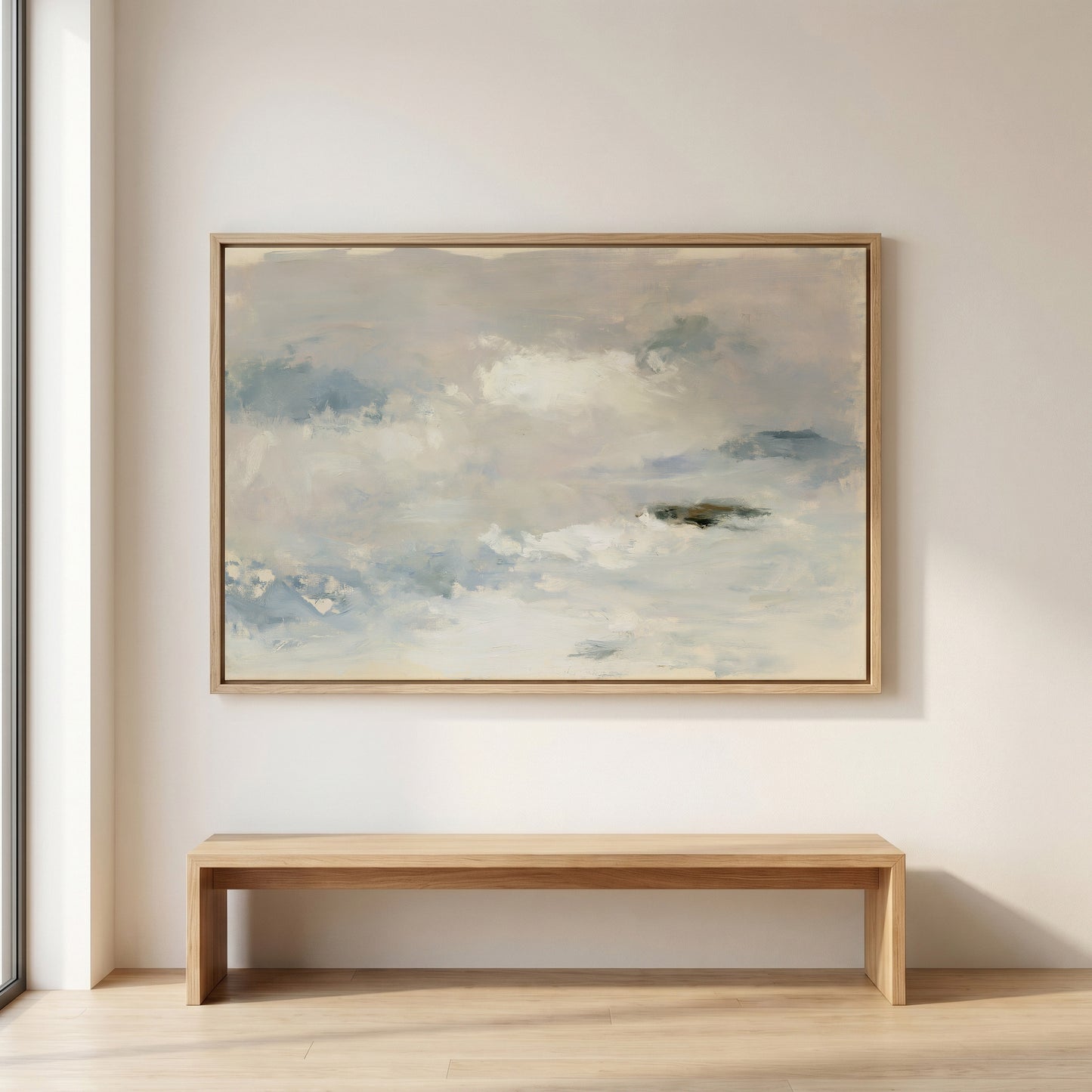 a large, framed painting of a cloudy sky hanging on a wall above a wooden bench.