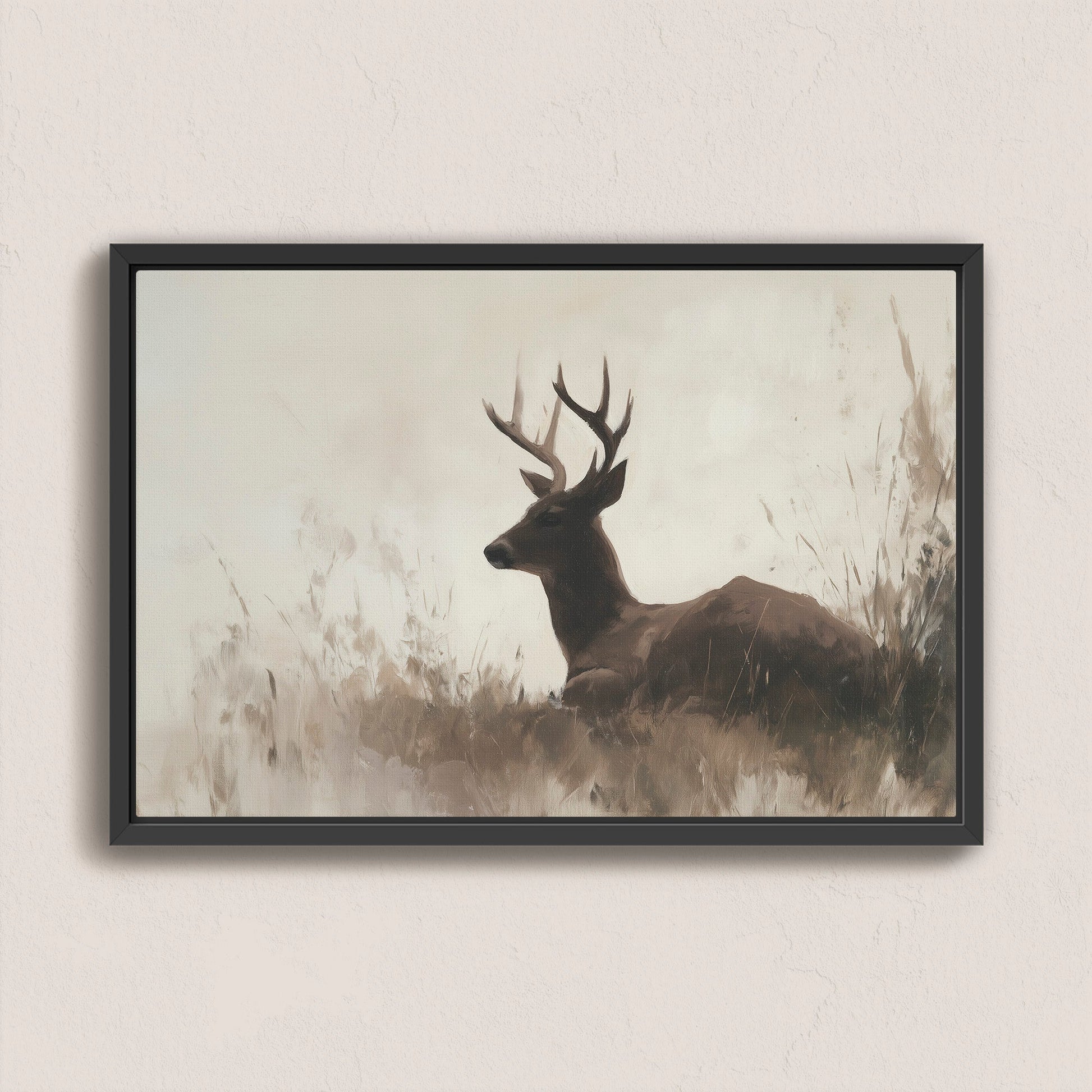 Haven Canvas Print of a resting deer in soft grasses with warm neutral tones in a black frame