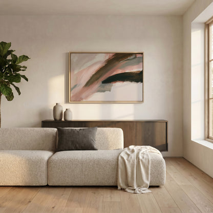 a modern living room with a large abstract painting on the wall, a white sofa, a wooden cabinet, and a large window.