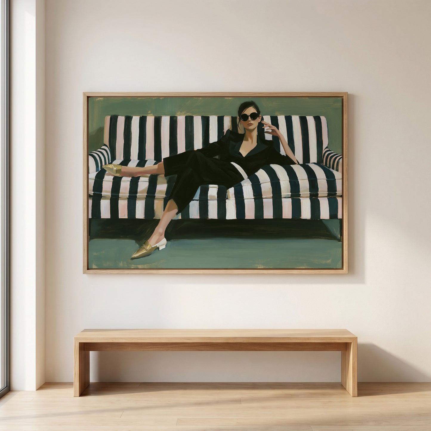 A woman is sitting on a striped couch in a stylish outfit, with a pair of sunglasses on her head.
