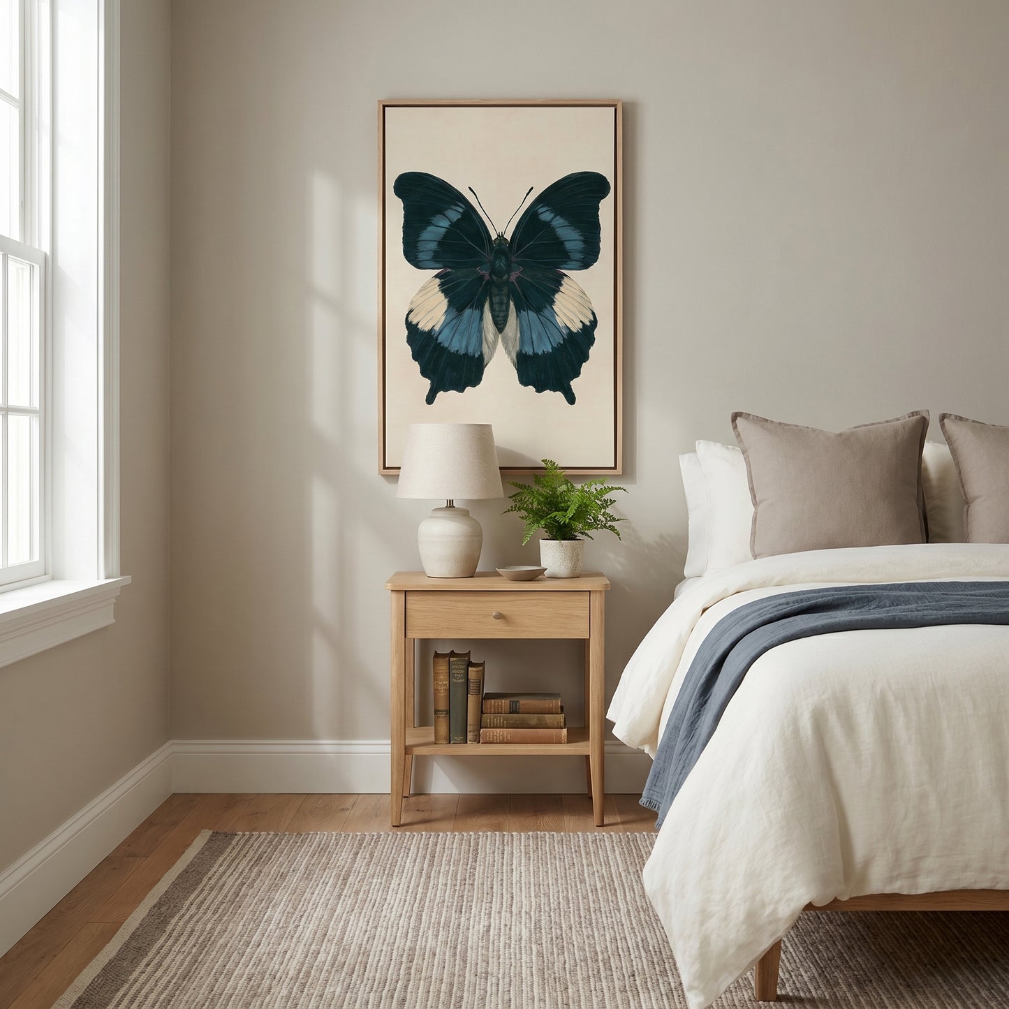 a serene and cozy bedroom with a large bed, a wooden nightstand, and a framed butterfly artwork on the wall.
