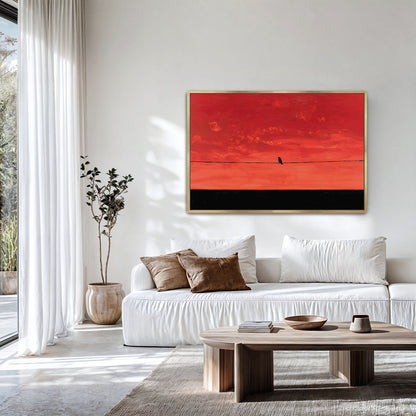 a modern living room with a white sofa, a wooden coffee table, and a large window overlooking a garden. A framed artwork of a bird on a wire is hanging on the wall above the sofa.