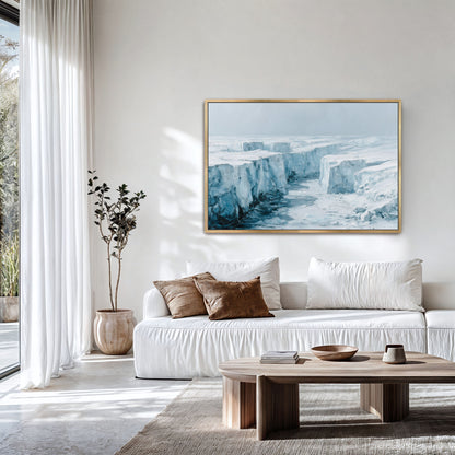 a modern living room with a large white sofa, a wooden coffee table, and a framed landscape painting of a snowy mountain scene hanging on the wall.