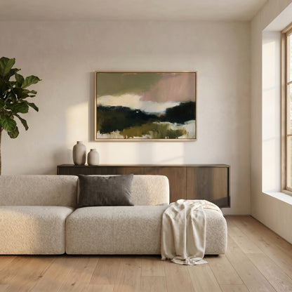a modern living room with a large window, a white sofa, a wooden cabinet, and a framed landscape painting on the wall.