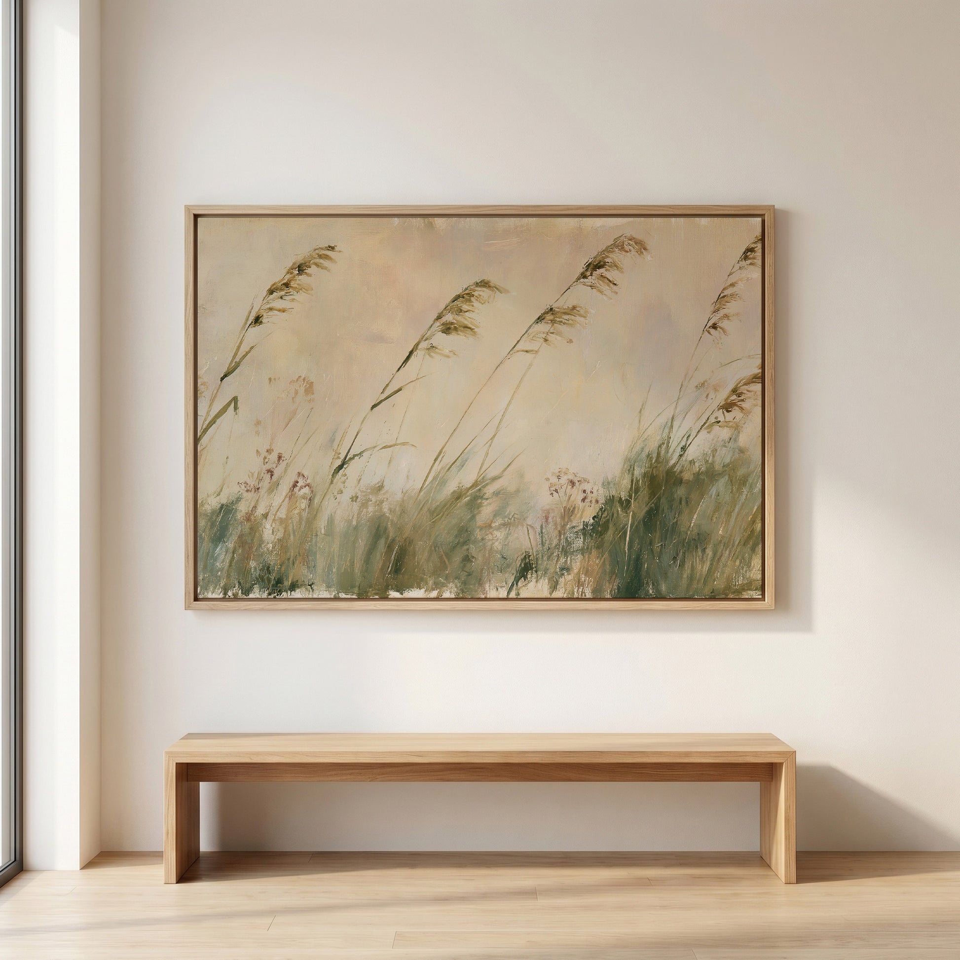 a large painting of tall grasses hanging on a wall above a wooden bench.
