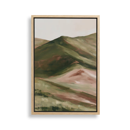 The image is a framed painting depicting a landscape with rolling hills and mountains in shades of green and brown.