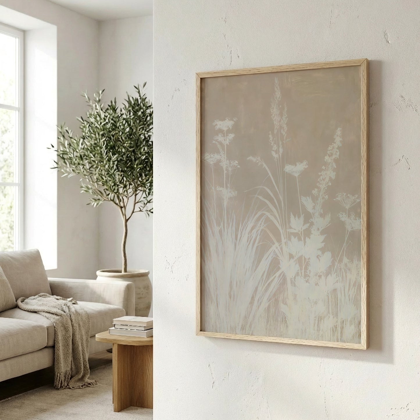 a cozy living room with a large window, a comfortable sofa, and a wooden coffee table. A framed artwork featuring a floral design hangs on the wall, adding a touch of nature and elegance to the space.